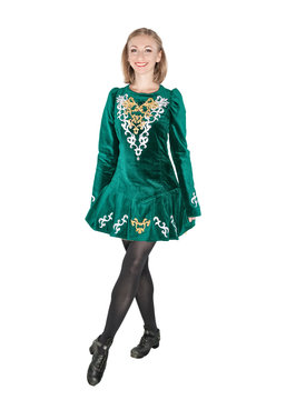 Beautiful young woman in Irish dance green dress isolated