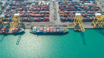 Fototapeta na wymiar Container ship in export and import business and logistics. Shipping cargo to harbor by crane. Water transport International. Aerial view and top view.