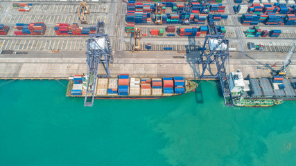 Fototapeta na wymiar Container ship in export and import business and logistics. Shipping cargo to harbor by crane. Water transport International. Aerial view and top view.