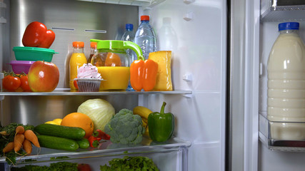Fototapeta na wymiar Refrigerator full of fruits and vegetables. Fridge icebox with wholesome food.