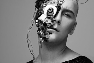 Monochrome studio photo of man cyborg, half face computer elements and with professional make-up,...