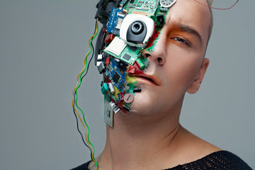 Studio photo of man cyborg, half face computer elements and with professional make-up, white...