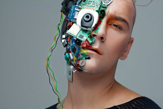 Studio photo of man cyborg, half face computer elements and with professional make-up, white Iroquois on head. Future technology concept