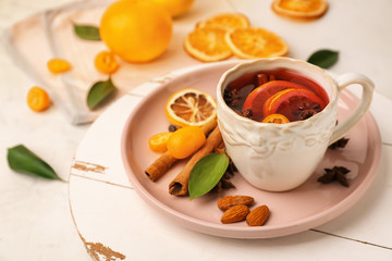 Cup of delicious mulled wine on light table