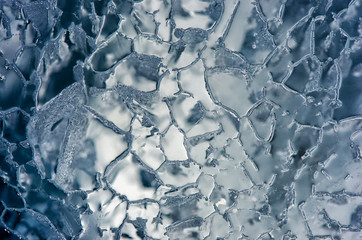 Blue cracked surface of the ice surface