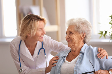 Doctor visiting senior woman at home