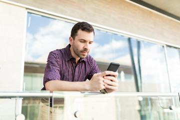 Blogger Reading Comments Under Post In Social Networks On Smartphone