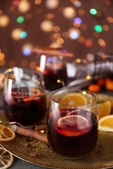 Glasses of delicious mulled wine on plate