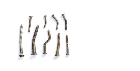 Deformed damaged metal screws collection on a white background. close-up photo, copy space