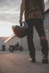 biker guy in front of classic style motorcycle