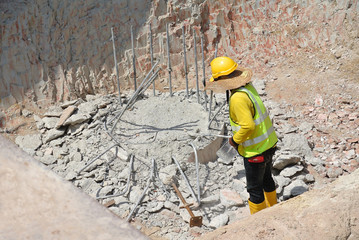 Reinforce concrete bore pile at the construction site. Cut to level to continue with pile cap and ground beam works. Transferring load from building to earth.  © Aisyaqilumar