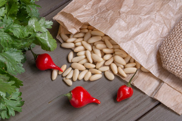 fresh pine nuts and chili peppers on wooden table