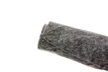Felt close-up on a white background. Gray felt twisted into a roll on a white background.