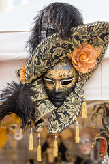 black Venetian mask with feathers, with the addition of orange and gold color