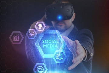 The concept of business, technology, the Internet and the network. A young entrepreneur working on a virtual screen of the future and sees the inscription: Social media