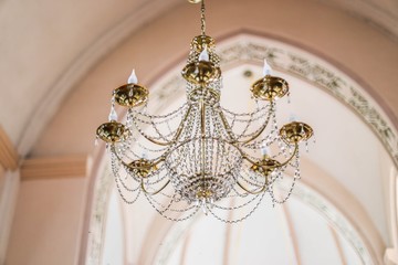 crystal chandelier in the temple, a large aristocratic hall.