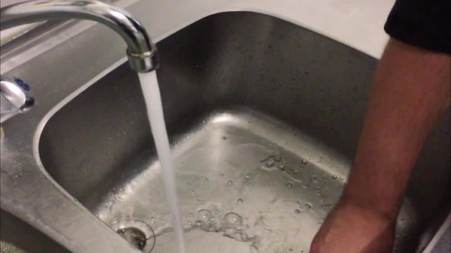 Using clean warm water for cleaning the kitchen with a cloth