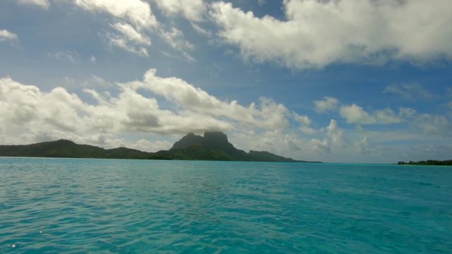 Sailing with a dingi over the ocean in front of Bora Bora in French Polynesia