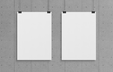 Two blank white poster hanging up with clips mockup