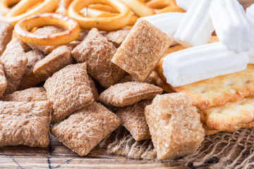 Assortment of cereal confectionery, marshmallow drying cookies on wooden background.