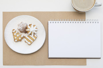 Holiday cookies and blank notepad background. Coffee Christmas mockup. Top view.
