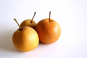 Whole Chinese pear or Nashi pear with stem on white background. Food concept.