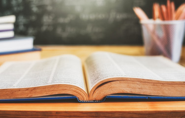 Open books with formulas on the chalkboard .education concept