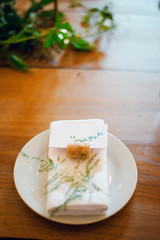 Flower arrangement in rustic style on the wooden table served for wedding dinner. Wedding decoration