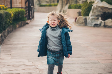 Funny little girl with closed eyes.