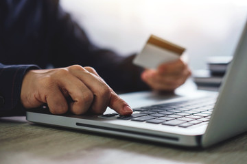 Man typing laptop for online shopping and pay by credit card, Online payment and shopping concept