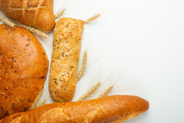 Fresh bread, Georgian lavash, diet bun and French baguette with wheat, isolate, concept bakery and fresh baked goods