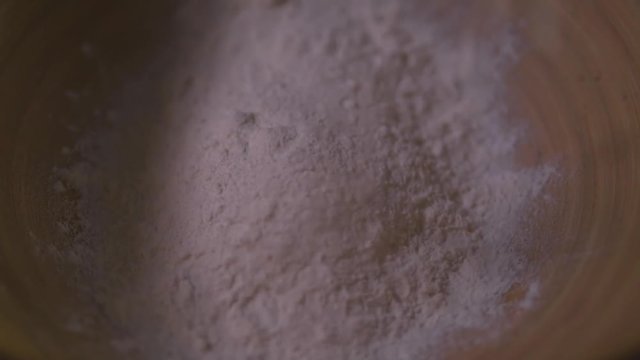 Flour is poured onto bowl
