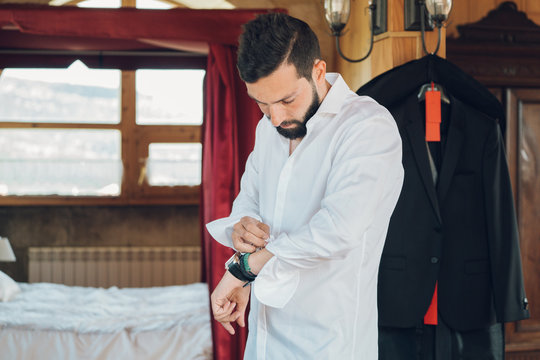 Young man dressing up in bedroom