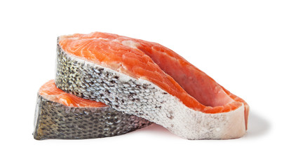 Raw salmon steaks slices, isolated on a white background.