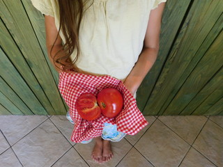 girl holding tomatoes