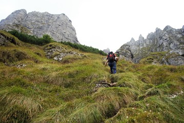 Image with a backpack traveler tracking on the mountain