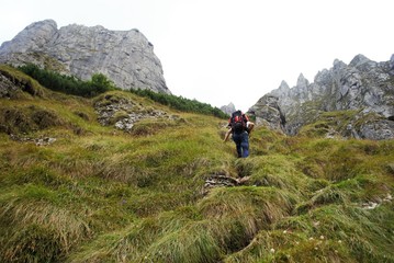 Obraz premium Image with a backpack traveler tracking on the mountain