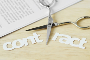 Scissors cutting the word Contract - Contract termination concept