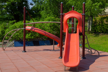 A red slide on the playground for children