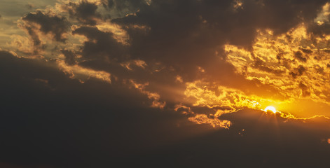 Sunset against the background of clouds