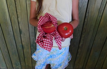 girl holding tomato