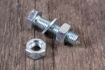 bolt, waher and nut on wooden background