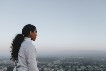 Woman enjoying the city view from a hill