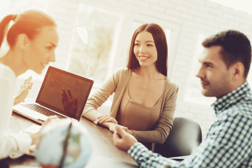 Young Man and Woman in Travel Agency with Manager.