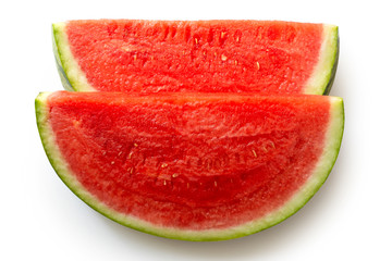 Two slices of seedless watermelon isolated on white from above.