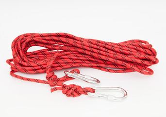 a red climbing rope with snap hooks