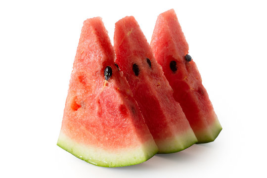 Three standing watermelon triangles with seeds  isolated on white.