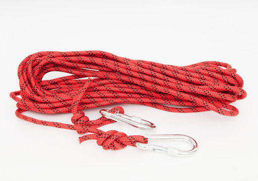 a red climbing rope with snap hooks