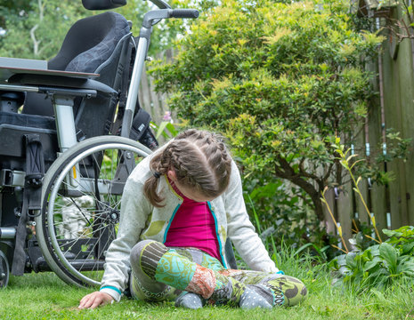 Disability A Disabled Child Relaxing In The Garden