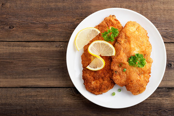 Homemade breaded german weiner schnitzel with potatoes. top view